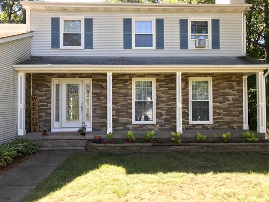 Canyon's Edge faux stone panel in Gray Fox – exterior siding and front yard installed by a DIY homeowner
