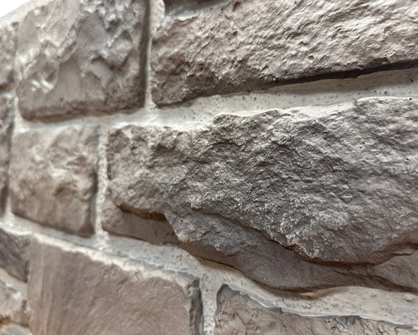 Close-up of Cotswold Stone in Abbey Gray showing the warm gray limestone texture and irregular stone faces
