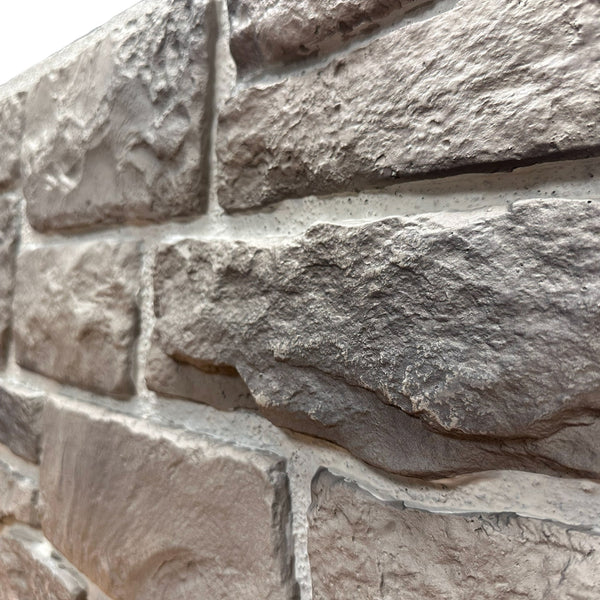 Close-up of Cotswold Stone in Abbey Gray showing the warm gray limestone texture and irregular stone faces