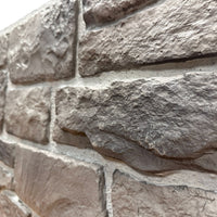 Close-up of Cotswold Stone in Abbey Gray showing the warm gray limestone texture and irregular stone faces