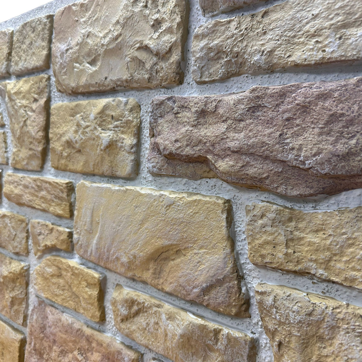 Close-up of Cotswold Stone in Heritage Gold showing the golden aged limestone texture and irregular stone faces