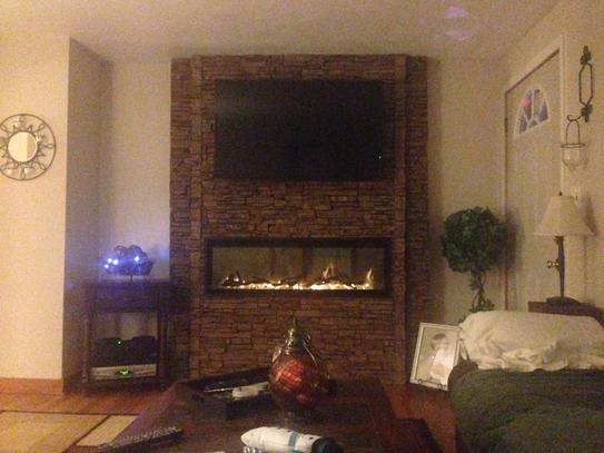 Lightning Ridge faux stone panel in Cappuccino – fireplace surround and accent wall installed by a DIY homeowner